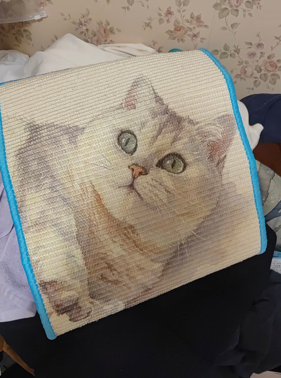 Customer holding a blue-edged custom cat portrait scratcher to show its printed surface